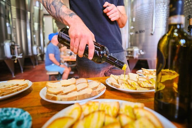 Chianti Vineyards Escape from Florence with Two Wine Tastings - Tasting Chianti with food on the table