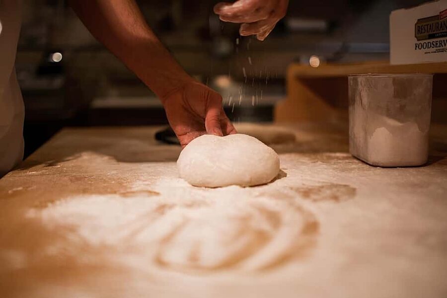 Florence: Private Pizza Making Class with Wine Tasting - Working the wood-fired oven